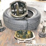 The output shaft flanges and the bearing caps removed from the differential.  Take care to keep these items in order.  They should be reinstalled on the same side and the same orientation they were removed from.