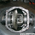 Once everything cools down, reinstall the final drive gear and insert the diff gears back into the housing taking care to install the bearings, spacers and bearing caps back in their proper locations.