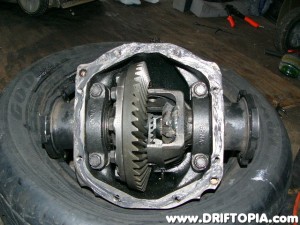 Once everything cools down, reinstall the final drive gear and insert the diff gears back into the housing taking care to install the bearings, spacers and bearing caps back in their proper locations.
