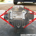 Remove the 8 bolts at the rear of the differential and pull the back covver off.