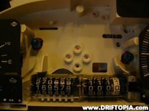 The speedometer pulls out of the cluster exposing the odometers.
