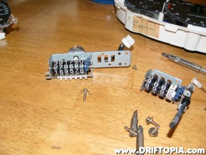 Remove the two screws that hold the two side of the odometer together.