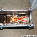 ca18det0ttpulsarmanifold210 After removing the long plate, remove the short one and expose the back side of the nipple outlet. Now is also a good time to use a little bit of Gumout and clean the valve cover.