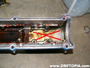 After removing the long plate, remove the short one and expose the back side of the nipple outlet.  Now is also a good time to use a little bit of Gumout and clean the valve cover.