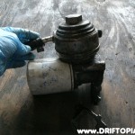 The oil cooler is built into the filter mount housing.  Coolant flows through the top via the two ports.