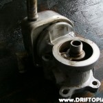 Use a can of Gumout and a lot of scrubbing to clean the outide of the housing.