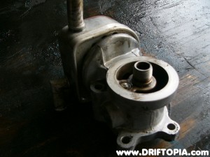 Use a can of Gumout and a lot of scrubbing to clean the outide of the housing.