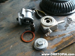 After removing the filter stud the cooler housing separates from the filter mount.  Once again, clean these parts thoroughly inside and out.  You don't want any of the old oil / sludge from the donor car to end up in your motor.