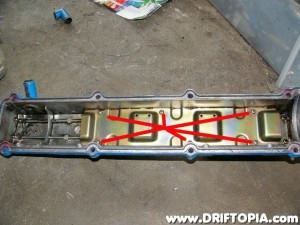 Flip the cover over and remove the 6 screws holding the long metal plate in.