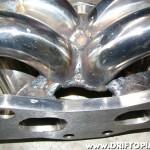 The collector is braced to the base of runners 2 and 3.  All welds were made with a mig welder using steel wire.  This works fine on stainless steel but does result in a little bit of spatter and an uglier weld.