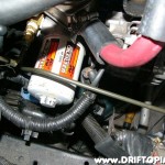 After loosely installing the line to the adapter port, another 45 degree bend angles the line towards the radiator.