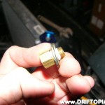 The 1/8" by 1/4" inch adapter is padded with 2 x 5/16" washers before threading into the built in cooler.