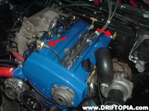 The arrows show the new valve cover venting system.  I am adding a rear oil drain to the head and these small hard lines T together and then connect to a traditional oil catch can.