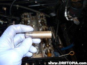 Using a grinder, you have to taper the end of a deep 13mm socket in order to reach the head bolts.