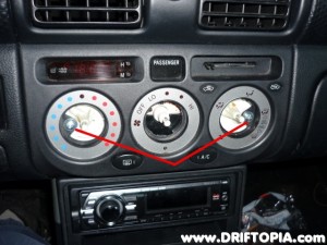 Remove the indicated screws and then pull the panel out of the dash.