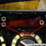 Press the two indicated tabs to pull the clock cover from the panel.