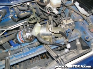 Tilt the pump to drain the reservoir fluid