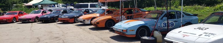 8 944 Spec racecars lined up at the Road Atlanta Paddock