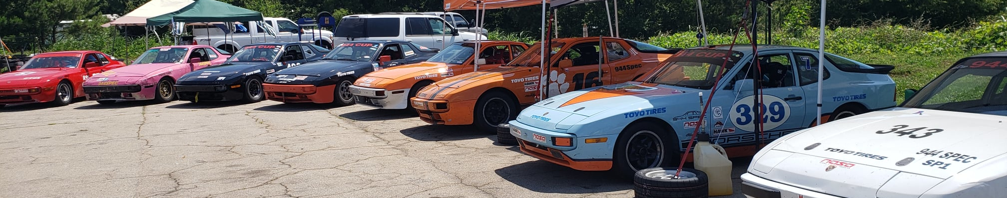 8 944 Spec racecars lined up at the Road Atlanta Paddock