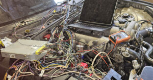 NA 1.6l Miata MX-5 with the wiring harness and ECU laying across the engine bay for troubleshooting.