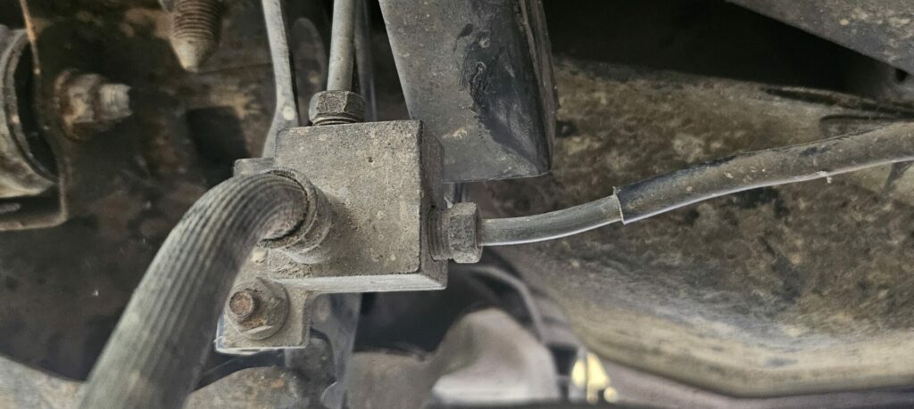 The rear brake line junction on the Mazda Miata.