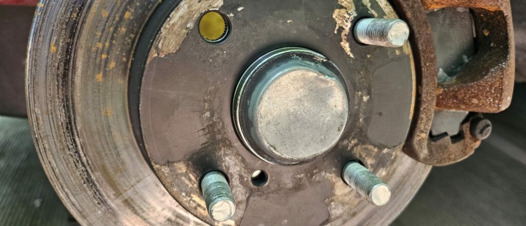 One removed wheel stud from the front miata hub to install longer wheel studs.