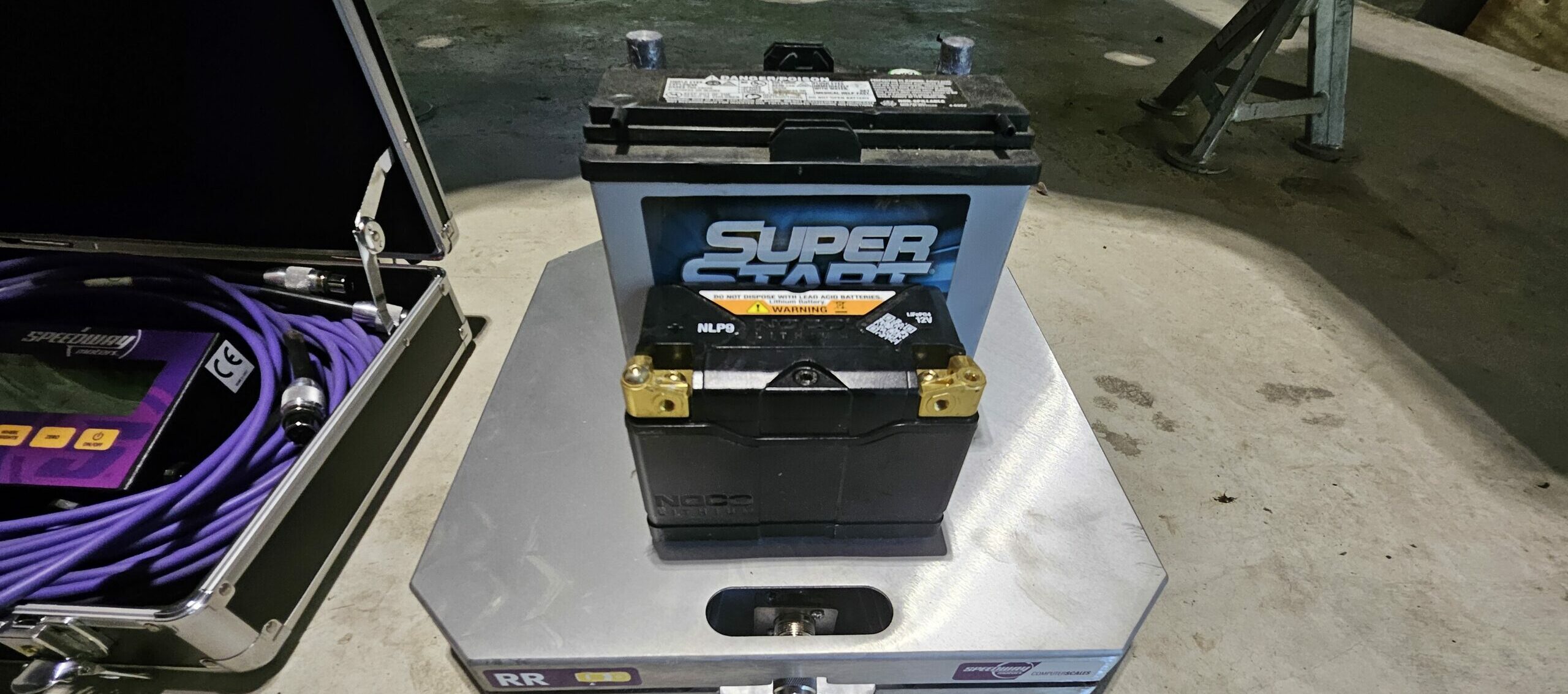 NOCO NLP9 lithium-ion battery next to the factory spec lead-acid miata battery.