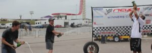 Three 944 Spec racers celebrating on the podium at Circuit of the Americas.