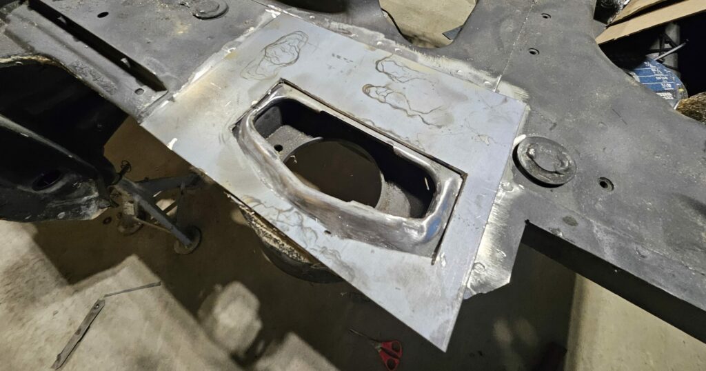 Steel plate for the rear strut mounting plate cut out and ready to be welded.