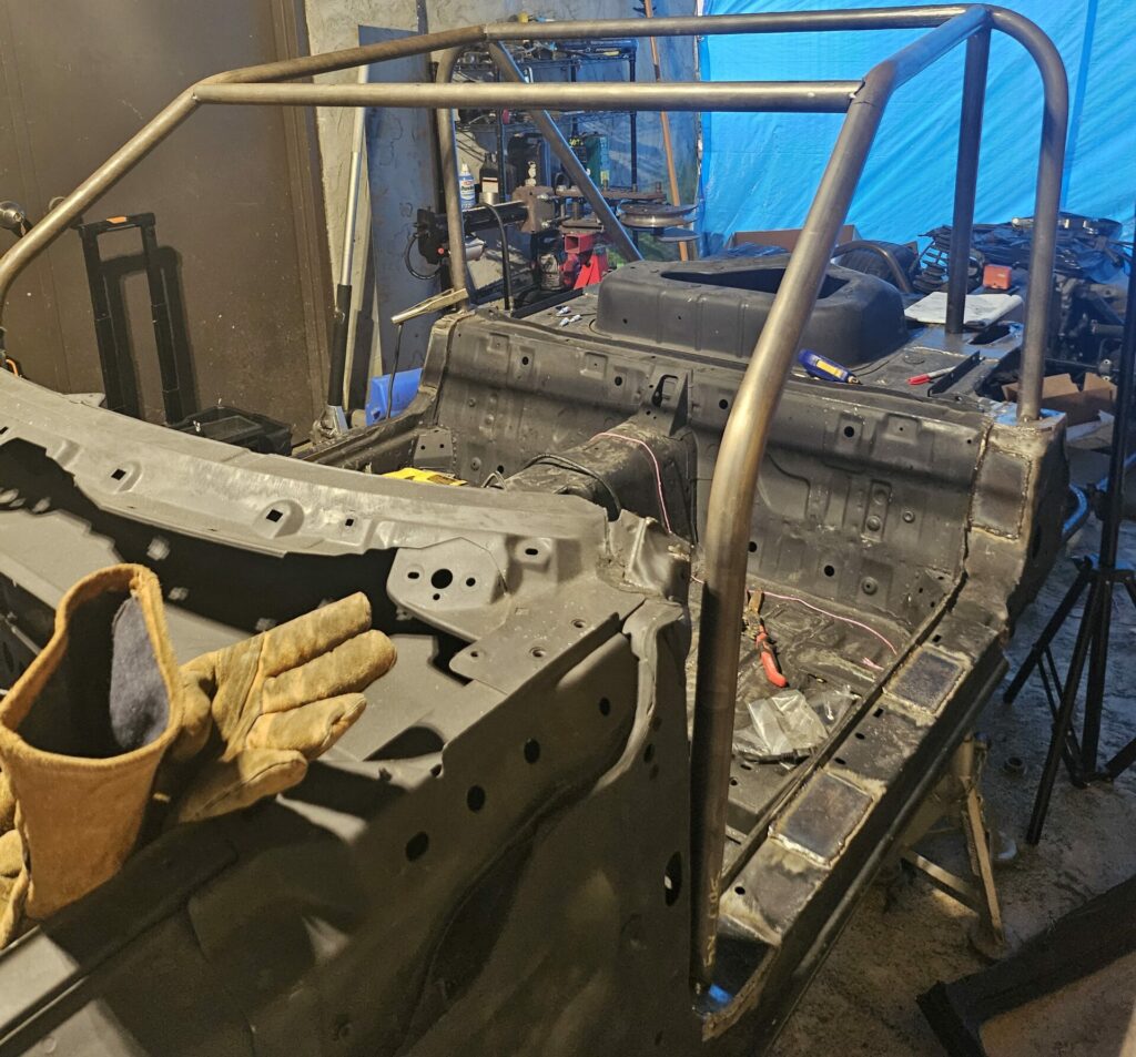 Showing the a-pillar bars of the 'ghettocet' roll cage that resulted in the removal of the windscreen.