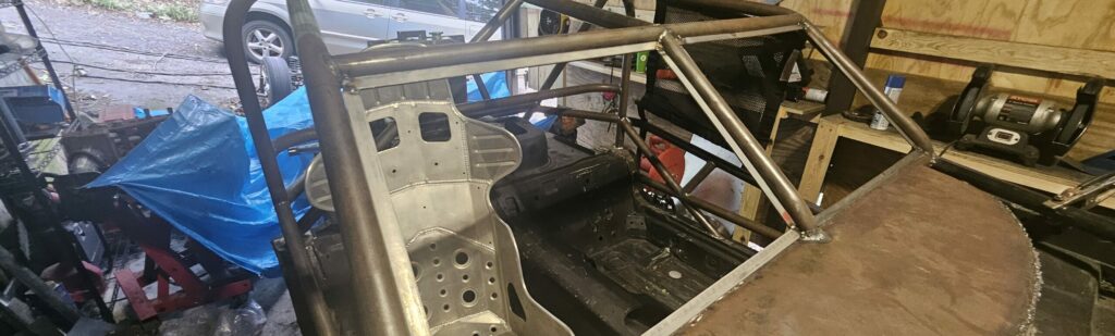 Window frames welded to the exo car ghettocet na miata.