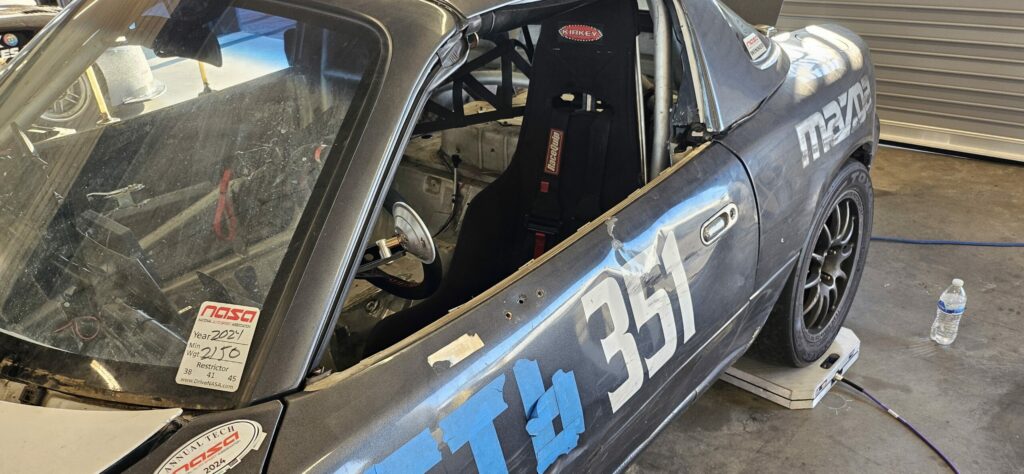 The NA Miata without side-view mirrors running in Super Touring 6.