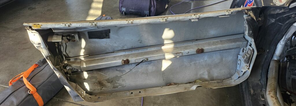 The driver's side door of the NA Super Touring 6 Miata after gutting the doors further.