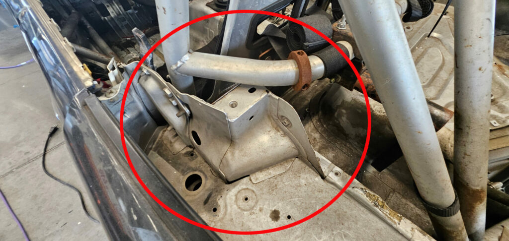 Highlight of the seatbelt mounts to be removed from the NA Super Touring 6 Miata.