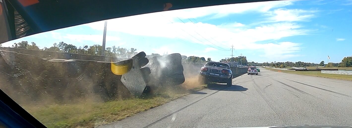 Hitting the tire wall at the national Corvette Museum in the Super Touring 6 Miata,