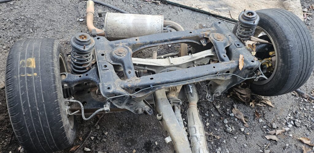 The rear drivetrain from the 1991 Mazda Miata Exo Car Ghettocet build exposed to the elements.