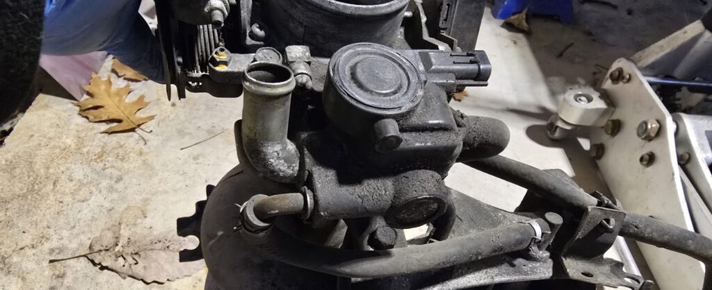 The Idle Speed Control Valve sits under the throttle body in NA Miata 1.6 