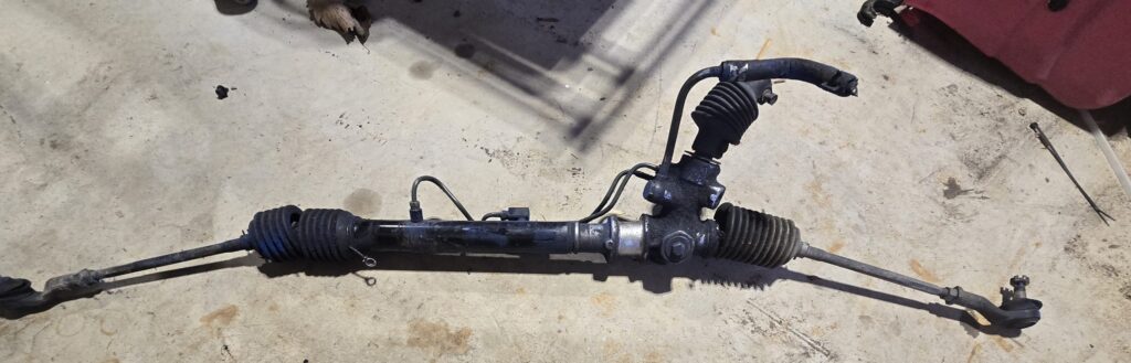 The steering rack from the na miata before depowering it.