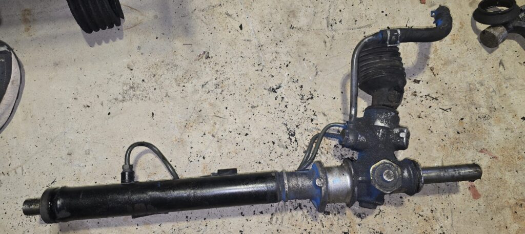 The tie-rods removed from the NA Miata steering rack.