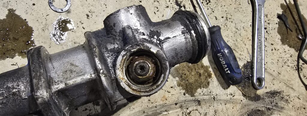 The bottom bolt on the steering pinion of the NA Miata.