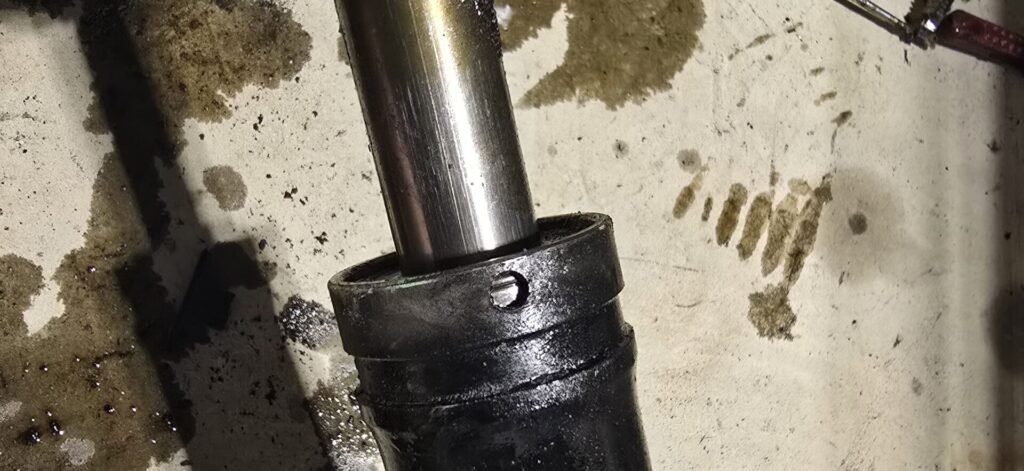 The small hole at the end of the na miata steering housing.