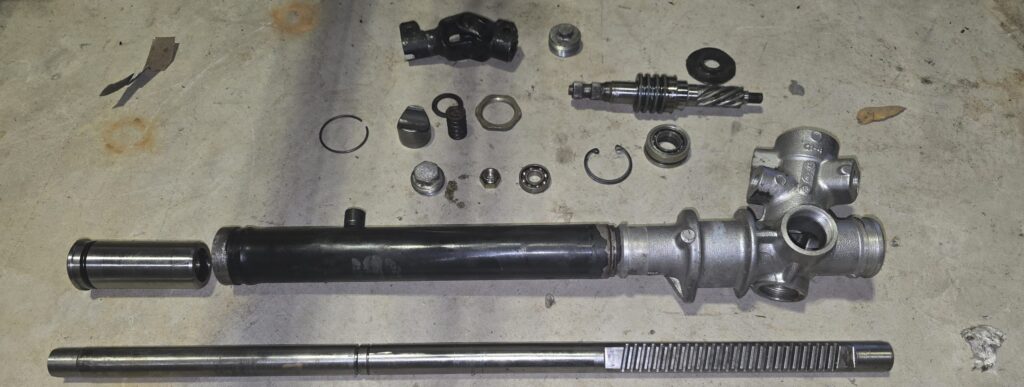 The steering rack components of the na miata after cleaning.