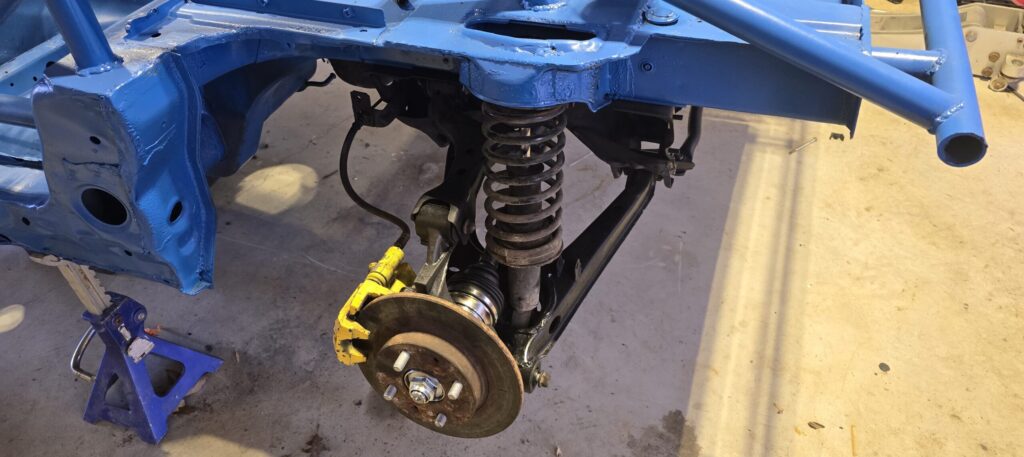 Rear suspension reassembled on the na miata.