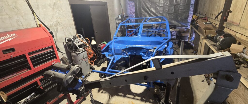 The engine and engine hoist staged to install the 1.6 l miata engine in the ghettocet.