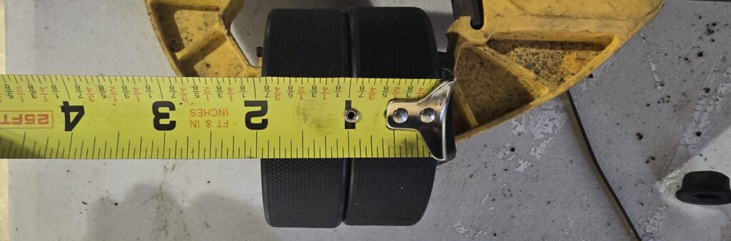Measuring the hockey pucks for the motor mounts.