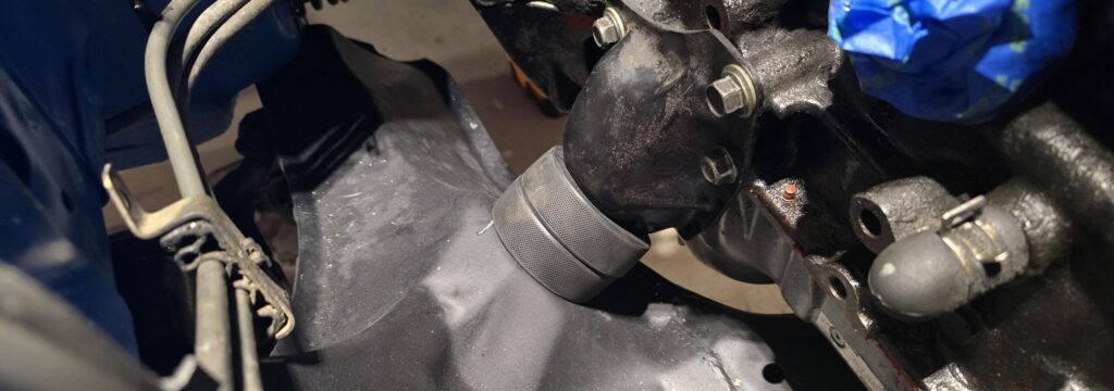 The hockey puck motor mount installed in the NA Miata.
