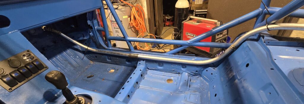 The cockpit run of the cold side coolant line in the rear mount radiator Miata. 