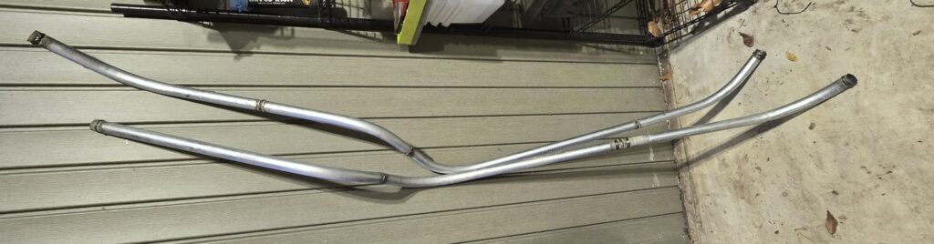 The cockpit coolant lines outside of the car on the rear mounted radiator miata.