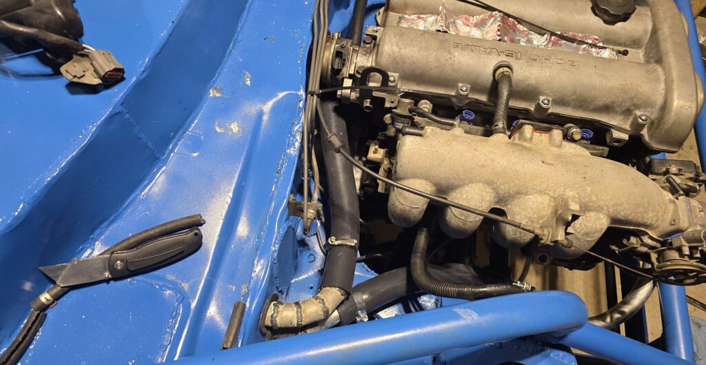 The silicone hose from the coolant reroute to the hot side firewall.