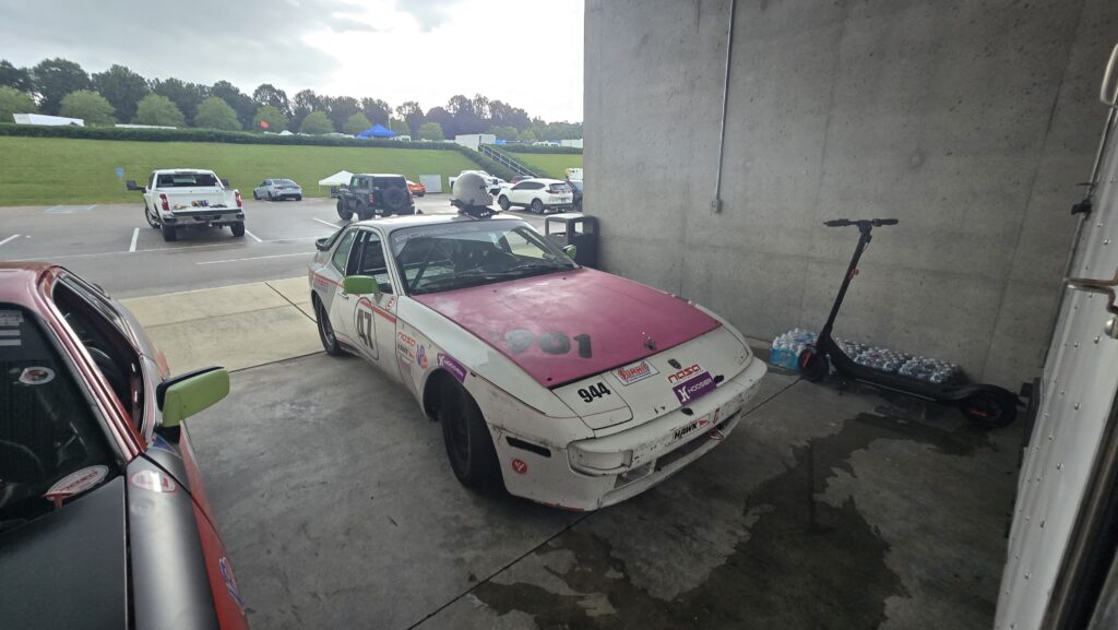 Someone forgot their hoodpins and ended up with a beautiful pink hood on their white 944 Spec.